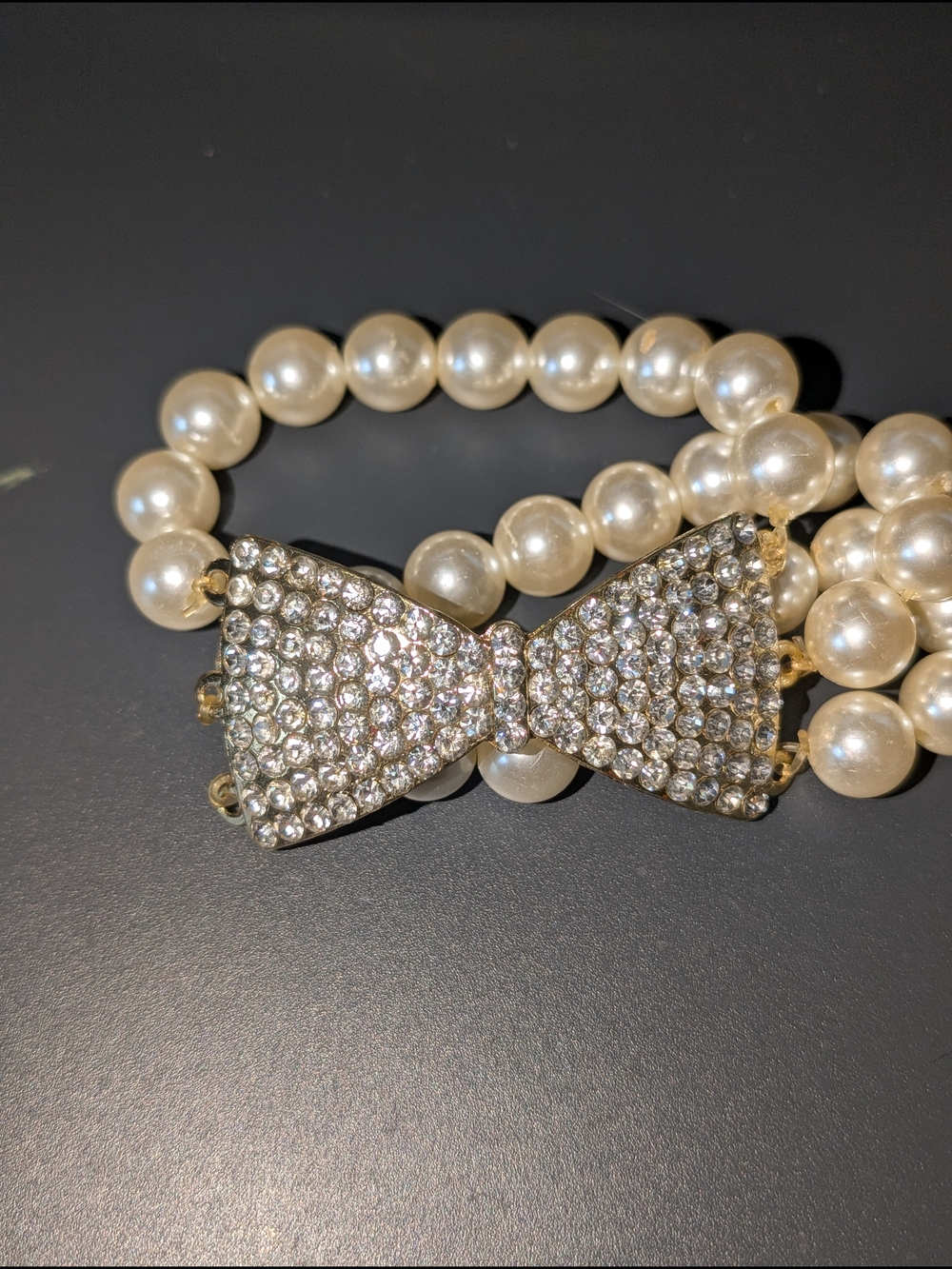 Bracelet With A Crystal-Encrusted Bow Centerpiece and Lustrous Faux Pearls
